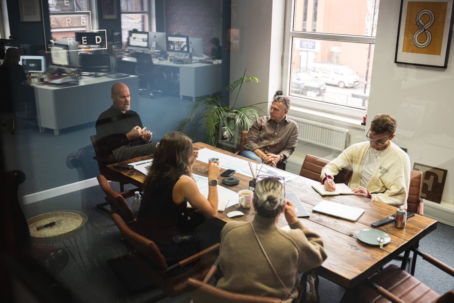 Team collaborating in We Are Fred studio workspace